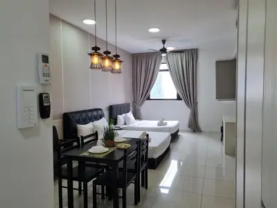 a room with a bed and a table and chairs at Chambers Suites KL By 969 in Kuala Lumpur