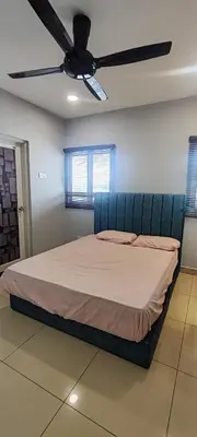 a bed in a room with a ceiling fan at Maxim Citylights in Kuala Lumpur