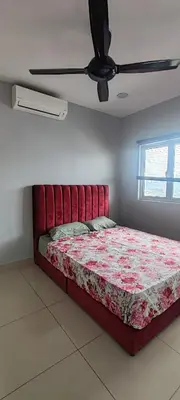a bed in a bedroom with a ceiling fan at Maxim Citylights in Kuala Lumpur
