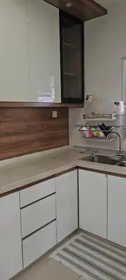 a kitchen with white cabinets and a sink at Maxim Citylights in Kuala Lumpur
