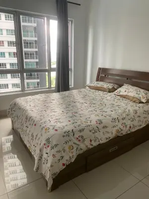 a bedroom with a bed with a floral bedspread and a window at DUDUhomes in Kuala Lumpur