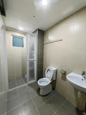 a bathroom with a toilet and a shower and a sink at DUDUhomes in Kuala Lumpur
