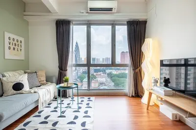a living room with a couch and a large window at Menara Arina Uniti 3km to KLCC 2BR 4Pax Mini Home in Kuala Lumpur