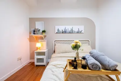 a bedroom with a bed with a vase of flowers on a table at Menara Arina Uniti 3km to KLCC 2BR 4Pax Mini Home in Kuala Lumpur