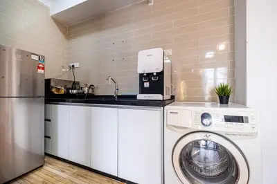 a kitchen with a washing machine and a washer at Menara Arina Uniti 3km to KLCC 2BR 4Pax Mini Home in Kuala Lumpur
