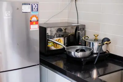 a kitchen counter with a toaster oven with pots and pans at Menara Arina Uniti 3km to KLCC 2BR 4Pax Mini Home in Kuala Lumpur