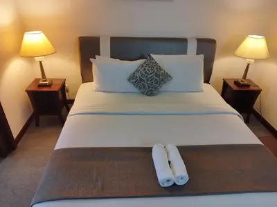 a hotel room with a bed with two towels on it at Eastern Suites Times Square KL in Kuala Lumpur