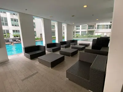 a lobby with chairs and a pool in a building at Skypool KL Free Infinity Pool over Kuala Lumpur in Kuala Lumpur