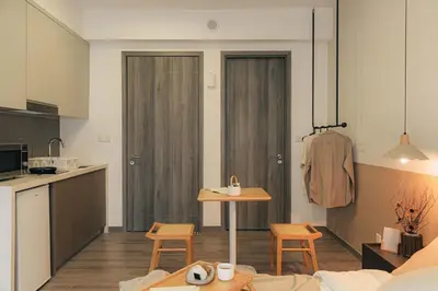 a kitchen and a living room with a table and chairs at Agile Bukit Bintang KLCC by DX in Kuala Lumpur