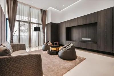 a living room with two chairs and a television at LUXE Infinitum KLCC by DX in Kuala Lumpur