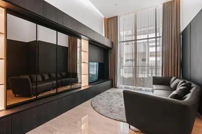 a living room with a couch and a large window at LUXE Infinitum KLCC by DX in Kuala Lumpur