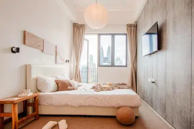 a bedroom with a bed and a large window at LUXE Infinitum KLCC by DX in Kuala Lumpur