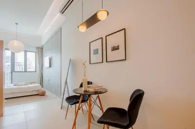 a room with a table and chairs and a bed at LUXE Infinitum KLCC by DX in Kuala Lumpur