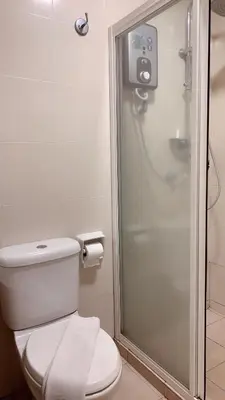 a bathroom with a toilet and a shower at 103 Hotel in Kuala Lumpur