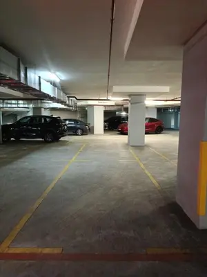an empty parking garage with cars parked in it at Arte Mont Kiara 4BR 8pax-10pax, 10mins to KLCC in Kuala Lumpur