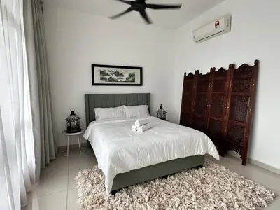 a bedroom with a large bed with a ceiling fan at Home away from home near KLCC in Kuala Lumpur