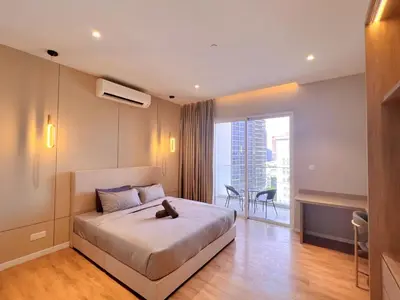a bedroom with a bed with a cat sitting on it at Lovely & Comfy Quill Residence, Near Monorail& Quill City Mall in Kuala Lumpur