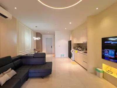 a living room with a couch and a flat screen tv at Lovely & Comfy Quill Residence, Near Monorail& Quill City Mall in Kuala Lumpur