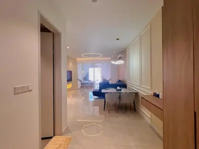 a living room with a table and a blue couch at Lovely & Comfy Quill Residence, Near Monorail& Quill City Mall in Kuala Lumpur