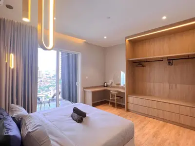 a bedroom with a bed with a black cat on it at Lovely & Comfy Quill Residence, Near Monorail& Quill City Mall in Kuala Lumpur