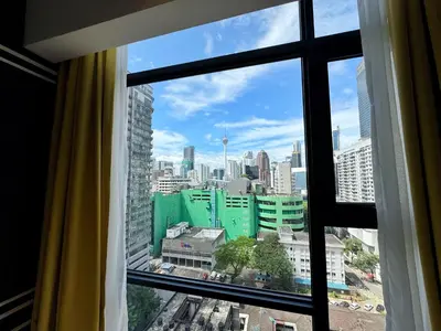 a view of a city skyline from a window at Axon Bukit Bintang Lovely 1BR Suite with KL View in Kuala Lumpur