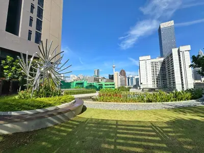 a park with a city in the background at Axon Bukit Bintang Lovely 1BR Suite with KL View in Kuala Lumpur
