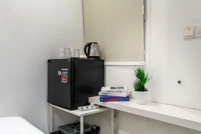 a black refrigerator sitting on a counter in a room at Backpackers Studio at Neu Suites Ampang in Kuala Lumpur
