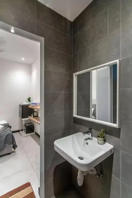 a bathroom with a sink and a mirror at Backpackers Studio at Neu Suites Ampang in Kuala Lumpur