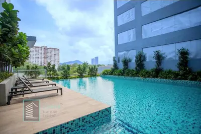 a swimming pool in front of a building at Backpackers Studio at Neu Suites Ampang in Kuala Lumpur