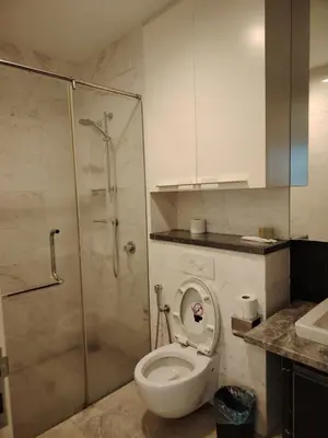 a bathroom with a shower and a toilet with the lid up at Platinum Kuala Lumpur by Sleepy Owl Suites in Kuala Lumpur