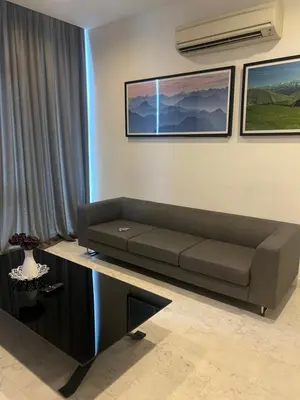 a living room with a couch and a table at Platinum Kuala Lumpur by Sleepy Owl Suites in Kuala Lumpur