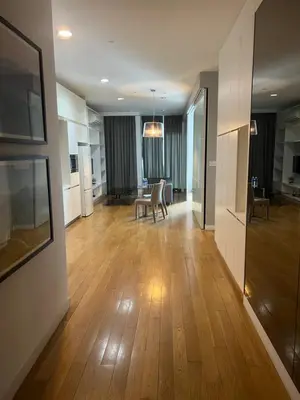 a living room with wooden floors and a dining room at Platinum Kuala Lumpur by Sleepy Owl Suites in Kuala Lumpur