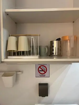 a shelf with three lamps and a no smoking sign at Matt suite home in Kuala Lumpur
