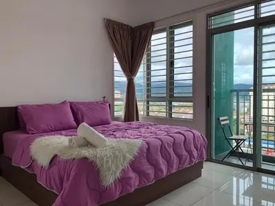 a purple bed in a room with a large window at Ampang 4-6 pax in Ampang Point in Ampang