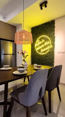 a dining room with a table and chairs and a sign at Agile Pavillion TRX Luxury Suited Kuala Lumpur Good View in Kuala Lumpur