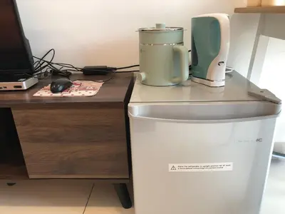 a appliance sitting on top of a refrigerator next to a desk at Ampang 2 -3 pax Studio Ampang Point in Ampang