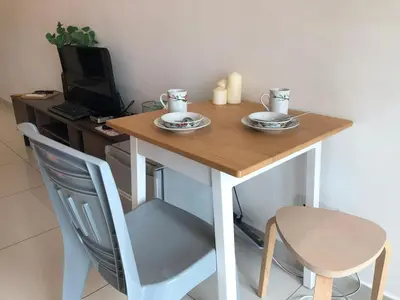 a wooden table with two plates on top of it at Ampang 2 -3 pax Studio Ampang Point in Ampang