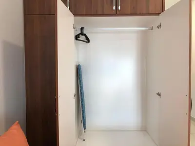 a white closet with a blue umbrella in it at Ampang 2 -3 pax Studio Ampang Point in Ampang