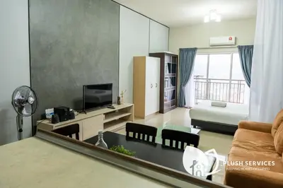 a living room with a couch and a table with a mirror at Windsor Tower Sri Hartamas by Plush in Kuala Lumpur
