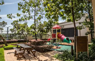 a playground with a slide and a picnic table at Windsor Tower Sri Hartamas by Plush in Kuala Lumpur