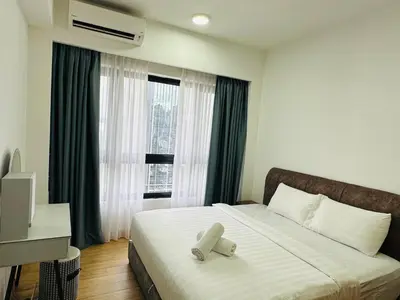a bedroom with a large bed with a window at Agile Residence TRX By Alltech Homes in Kuala Lumpur