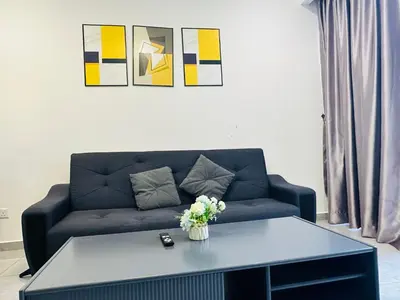 a living room with a couch and a table at Agile Residence TRX By Alltech Homes in Kuala Lumpur
