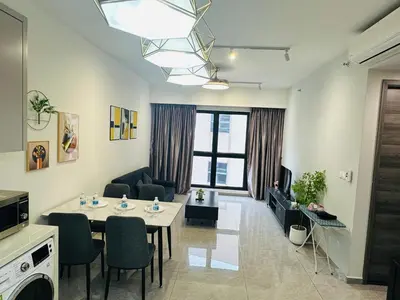 a living room with a table and chairs and a living room at Agile Residence TRX By Alltech Homes in Kuala Lumpur