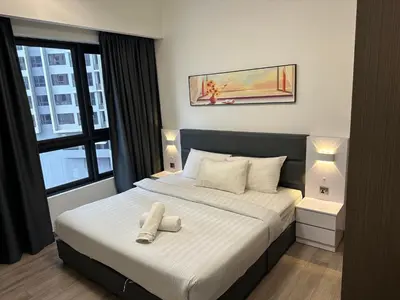 a bedroom with a bed with two white towels on it at Agile Residence TRX By Alltech Homes in Kuala Lumpur