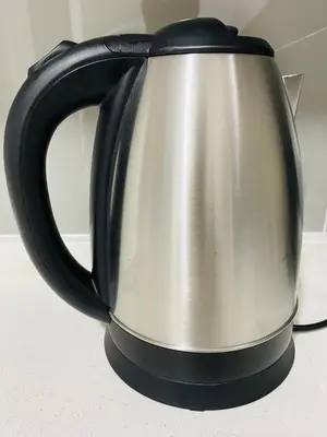 a black and silver tea kettle sitting on a counter at Agile Sky Pavilion Residence KL TRX by Moonlight in Kuala Lumpur