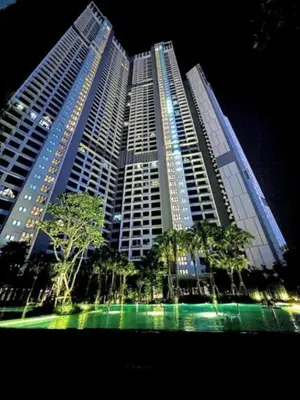 a large building with trees in front of it at Agile Sky Pavilion Residence KL TRX by Moonlight in Kuala Lumpur