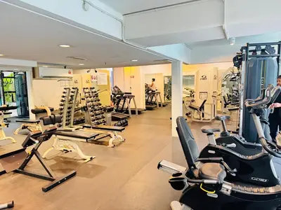 a gym with lots of treadmills and exercise bikes at Soha Homestay in Kuala Lumpur
