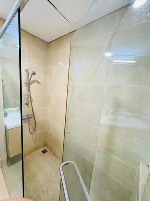 a shower with a glass door in a bathroom at Soha Homestay in Kuala Lumpur