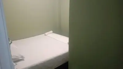 a small bedroom with a white bed in a room at Health Homestay KL in Kuala Lumpur