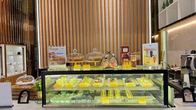 a display case in a store filled with food at XING LUN KLCC Platinum Suites in Kuala Lumpur